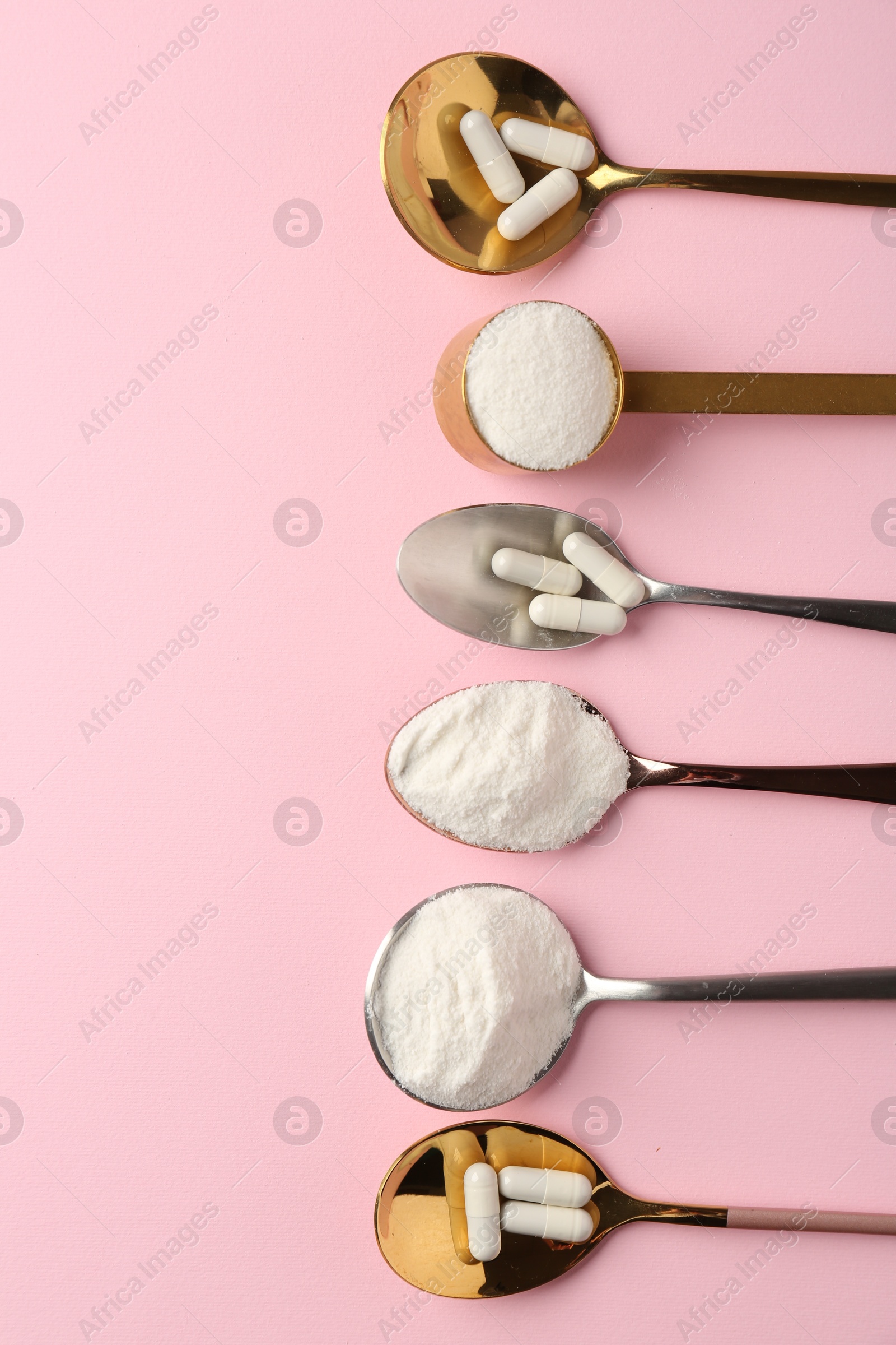 Collagen powder and pills on pink background, flat lay. Space for text Photo of Collagen powder and pills on pink background, flat lay. Space for text