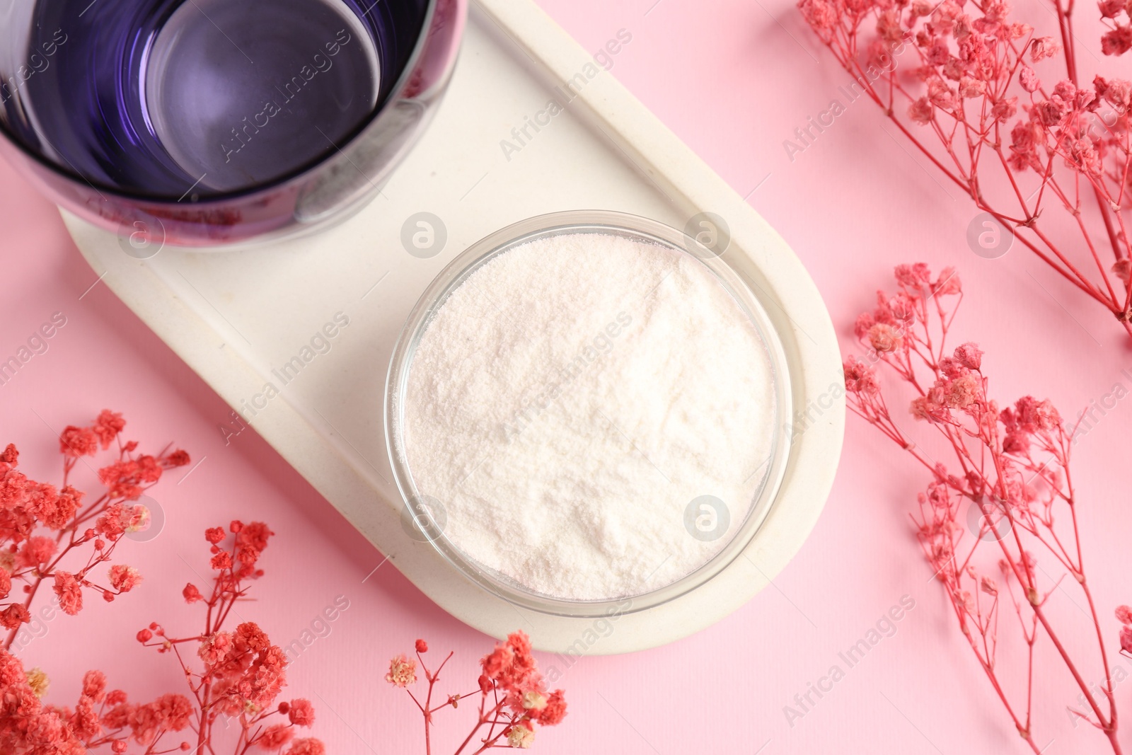 Collagen powder in bowl, glass and gypsophila branches on pink background, flat lay Photo of Collagen powder in bowl, glass and gypsophila branches on pink background, flat lay