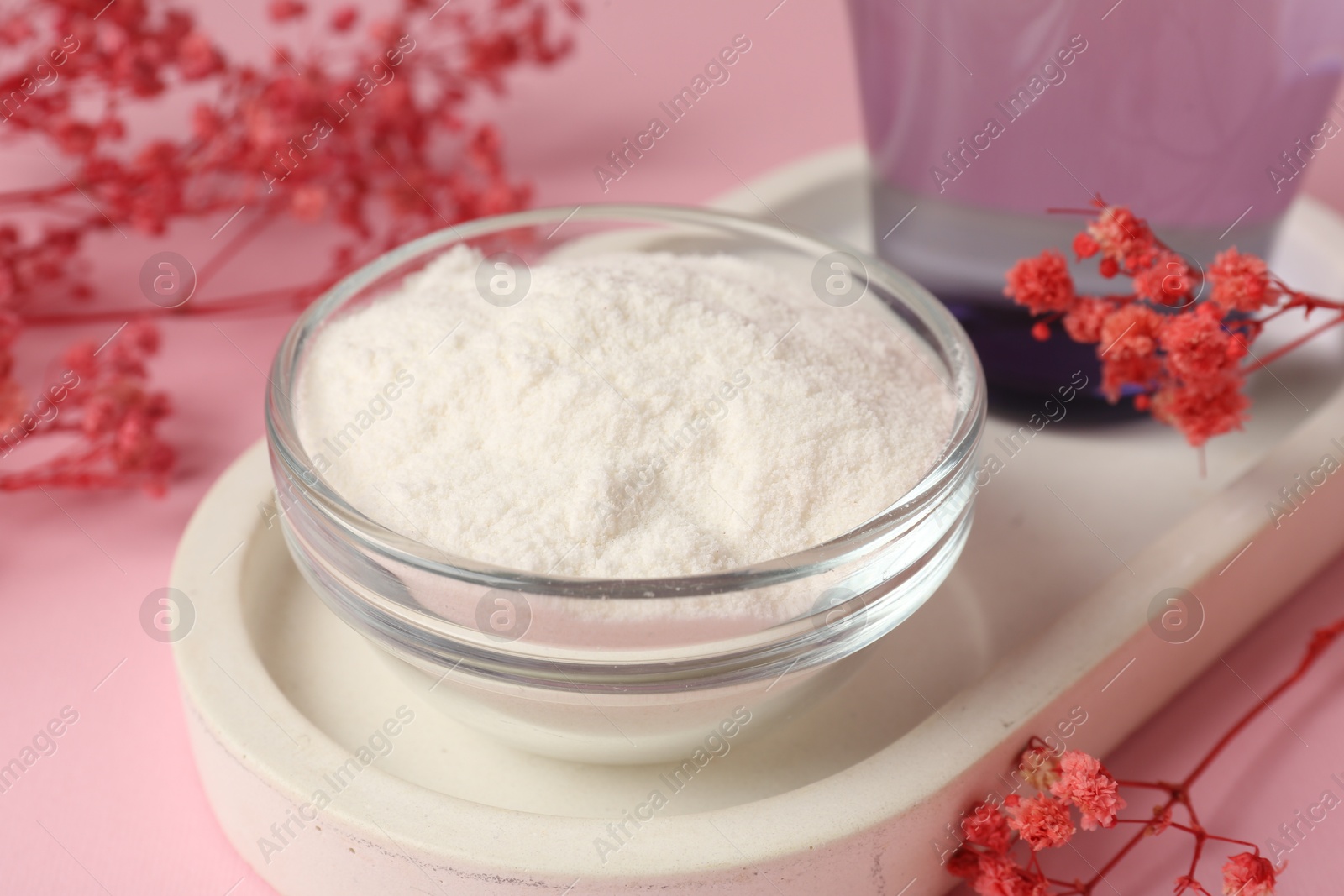 Collagen powder in bowl and gypsophila branches on pink background, closeup Photo of Collagen powder in bowl and gypsophila branches on pink background, closeup