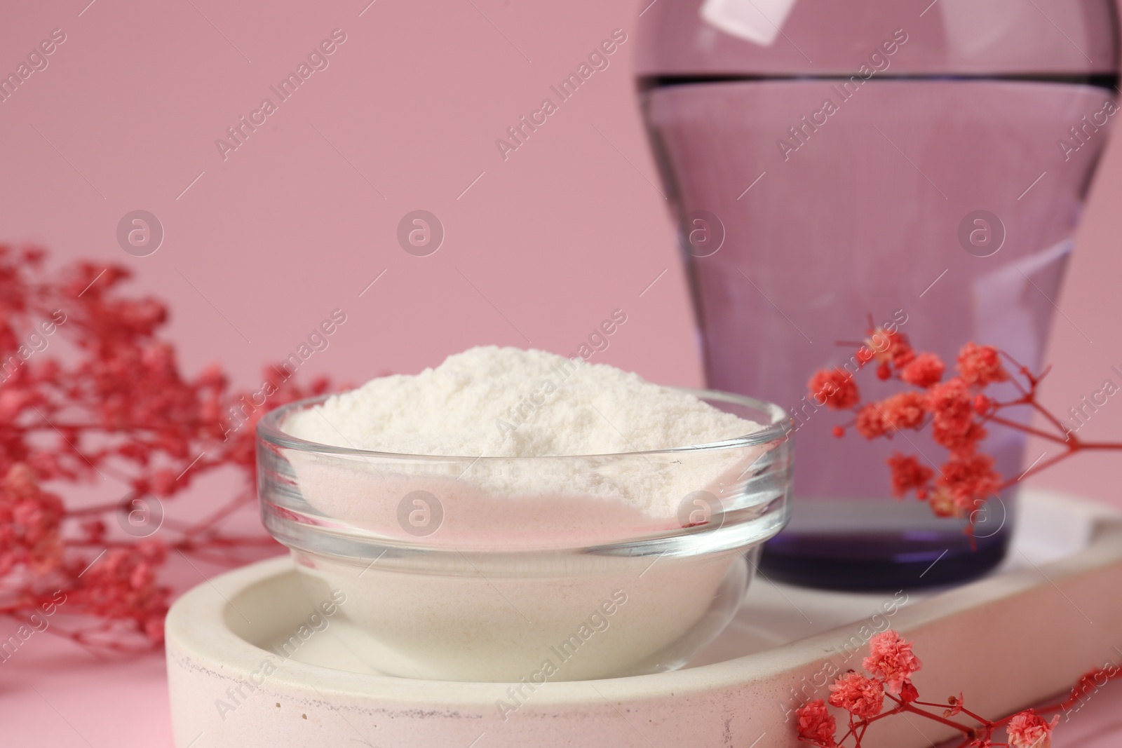 Collagen powder in bowl, glass of water and gypsophila branches on pink background, closeup Photo of Collagen powder in bowl, glass of water and gypsophila branches on pink background, closeup
