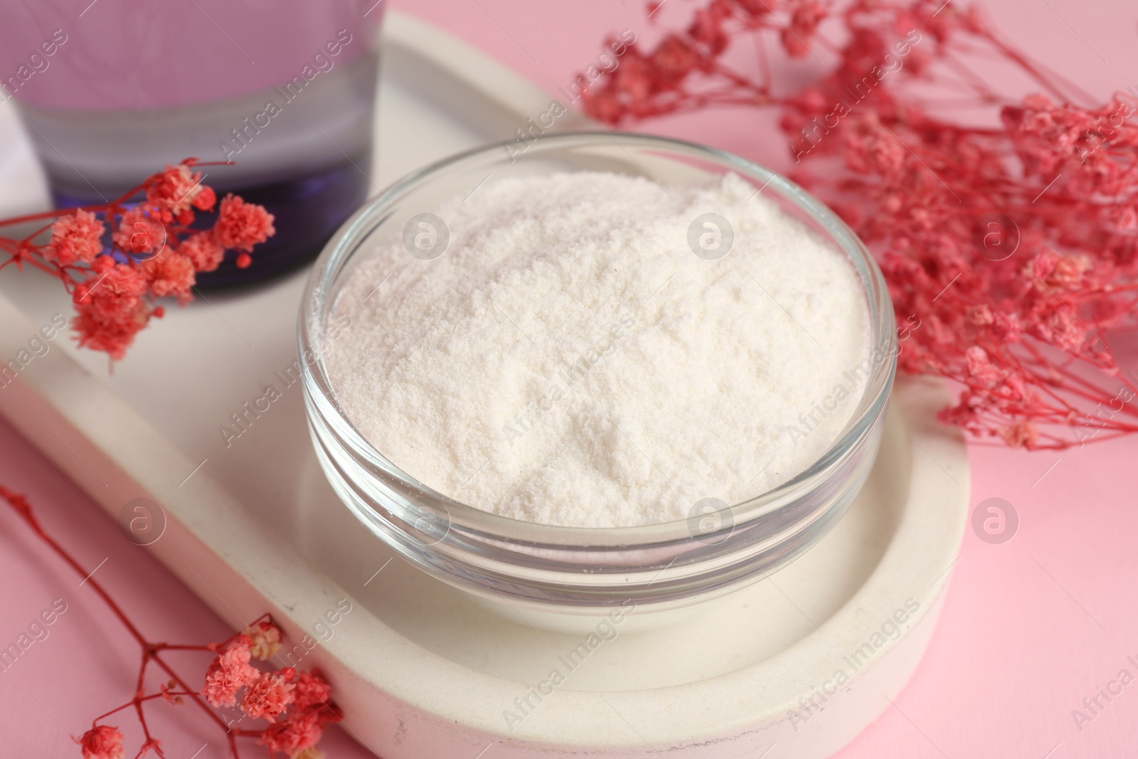 Collagen powder in bowl and gypsophila branches on pink background, closeup Photo of Collagen powder in bowl and gypsophila branches on pink background, closeup
