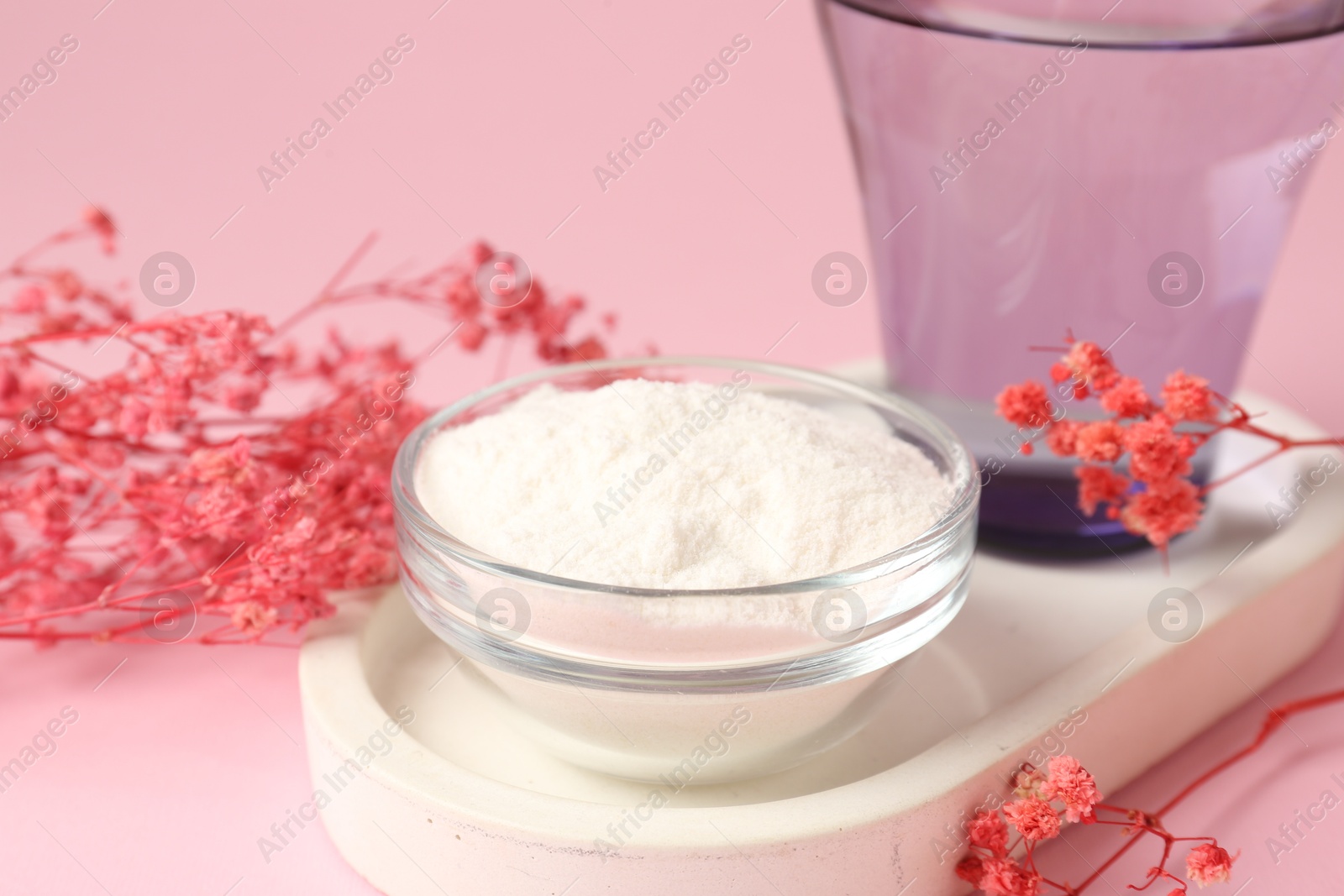 Collagen powder in bowl, glass of water and gypsophila branches on pink background, closeup Photo of Collagen powder in bowl, glass of water and gypsophila branches on pink background, closeup