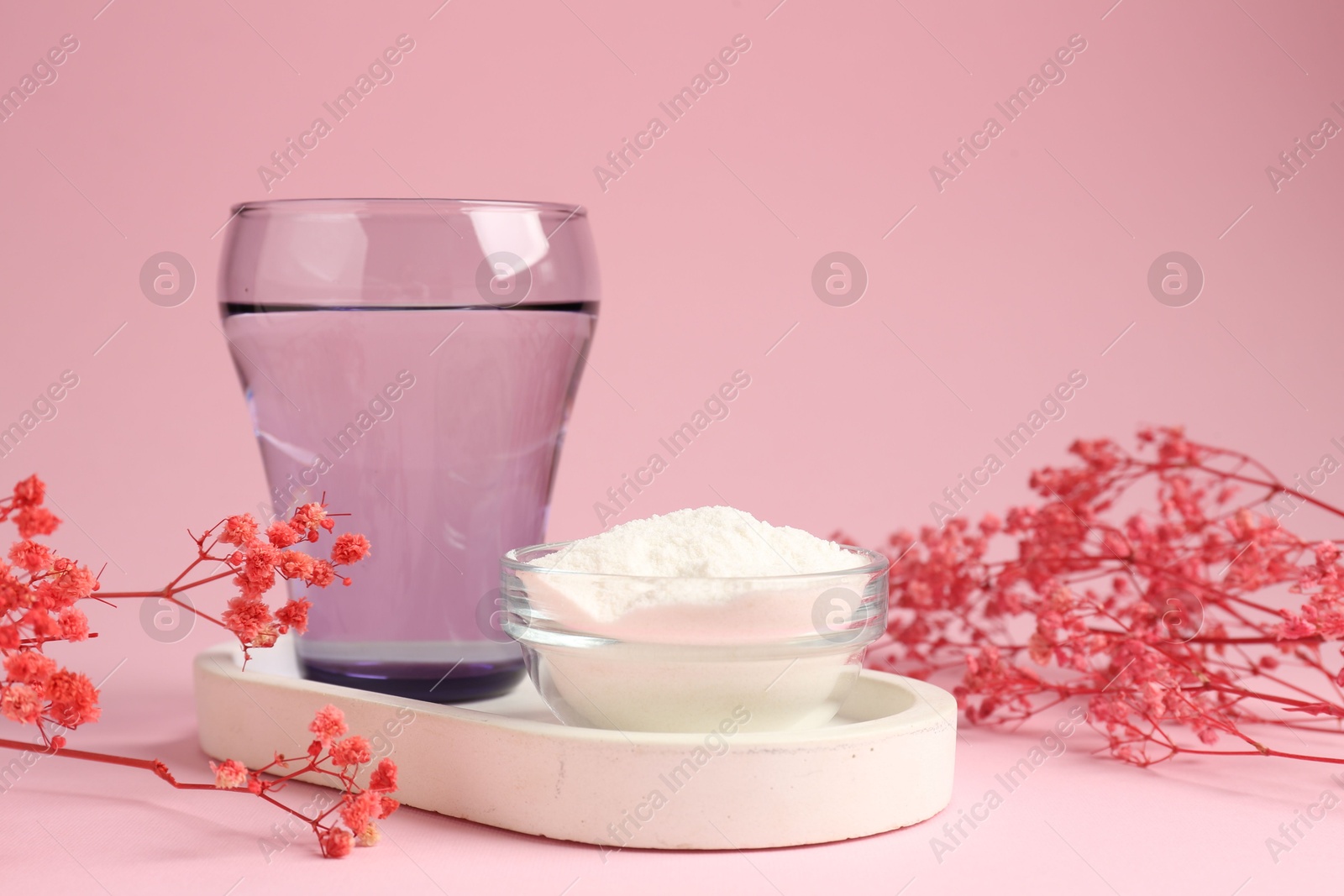 Collagen powder in bowl, glass of water and gypsophila branches on pink background, closeup Photo of Collagen powder in bowl, glass of water and gypsophila branches on pink background, closeup