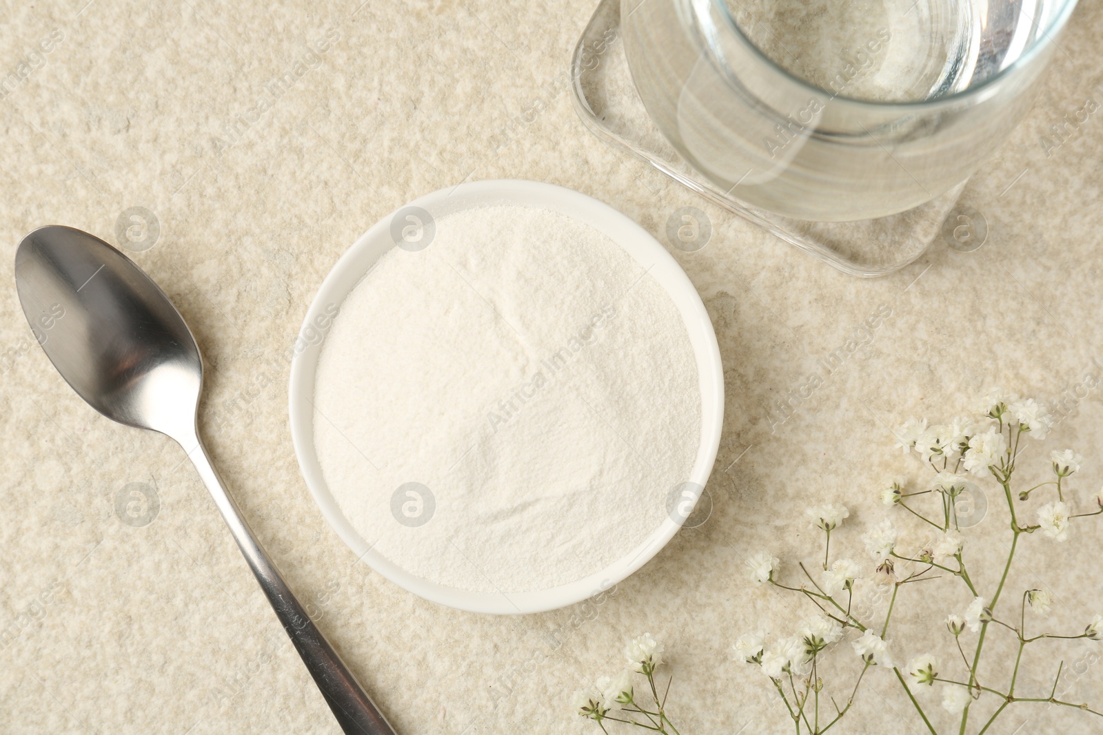 Collagen powder in bowl, spoon, glass of water and gypsophila branches on light textured table, flat lay Photo of Collagen powder in bowl, spoon, glass of water and gypsophila branches on light textured table, flat lay