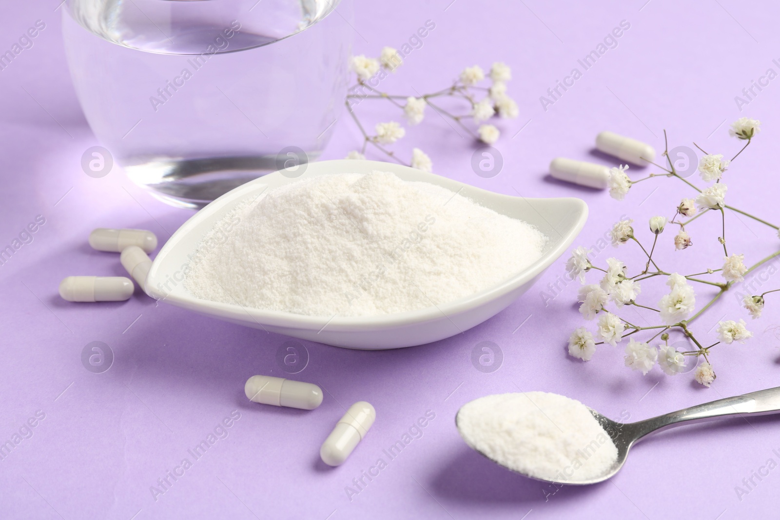 Collagen powder in bowl, spoon, pills, glass of water and gypsophila flowers on violet background, closeup Photo of Collagen powder in bowl, spoon, pills, glass of water and gypsophila flowers on violet background, closeup