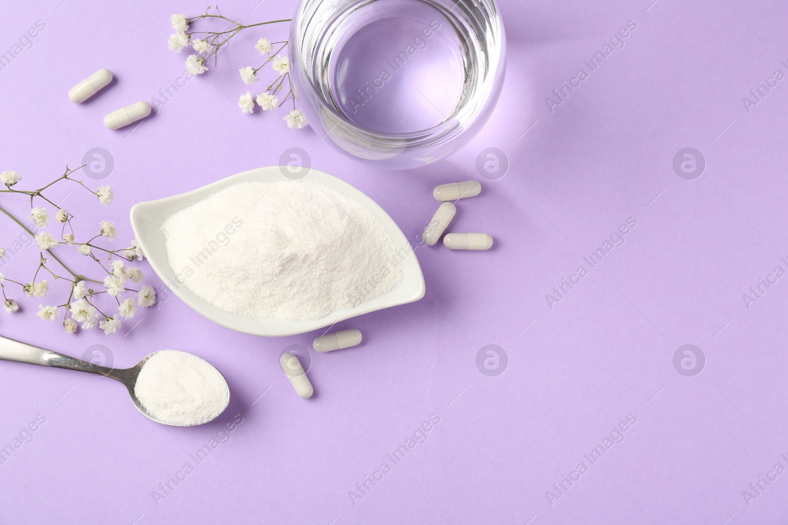 Collagen powder in bowl, spoon, pills, glass of water and gypsophila flowers on violet background, flat lay. Space for text Photo of Collagen powder in bowl, spoon, pills, glass of water and gypsophila flowers on violet background, flat lay. Space for text