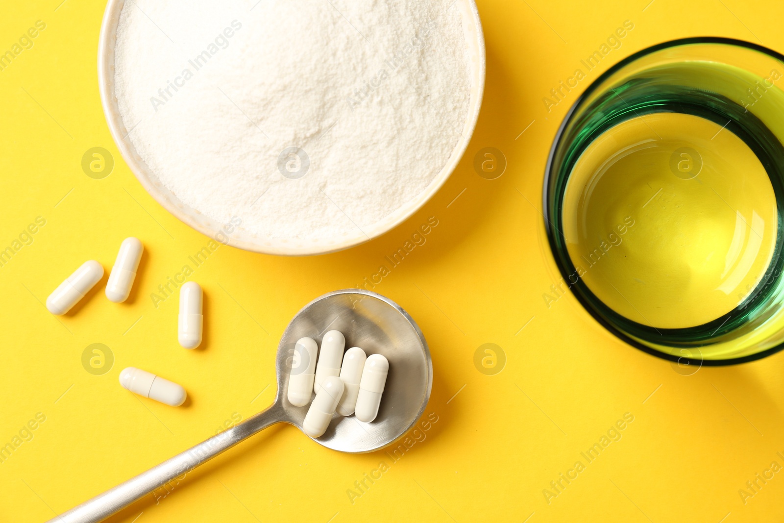 Collagen powder in bowl, spoon with pills and glass of water on yellow background, flat lay Photo of Collagen powder in bowl, spoon with pills and glass of water on yellow background, flat lay