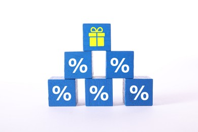 Image of Cube with gift box image on top of pyramid of other ones with percent signs against white background