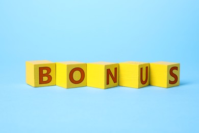 Image of Word Bonus made of yellow cubes with letters on light blue background