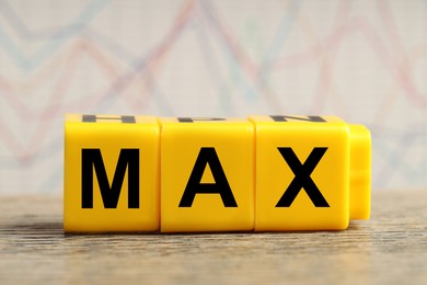 Image of Yellow cubes with word Max on wooden table