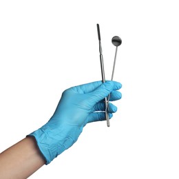 Photo of Doctor in medical glove holding metal tools on white background, closeup