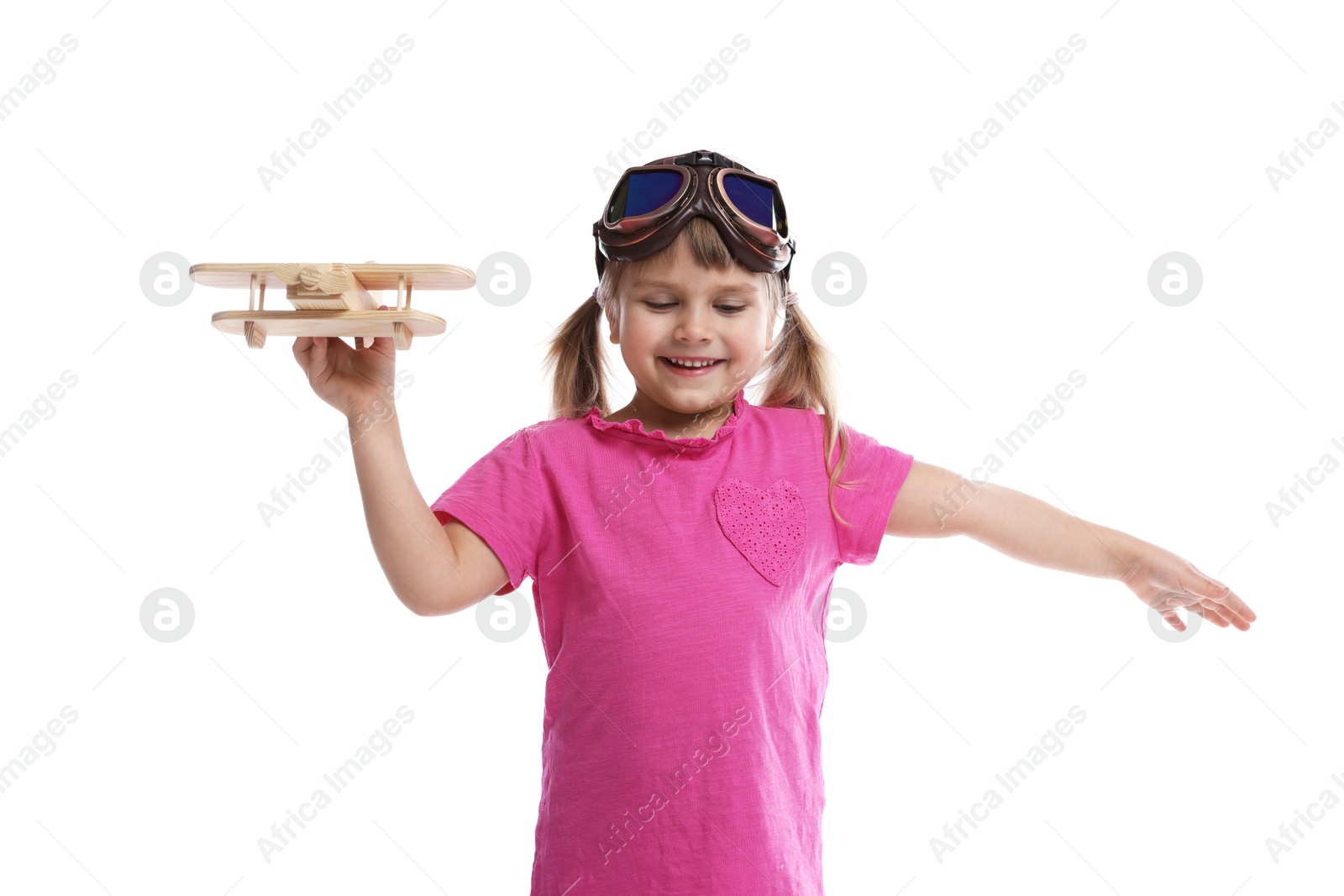 Photo of Cute little girl playing with toy plane on white background