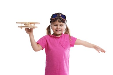 Cute little girl playing with toy plane on white background