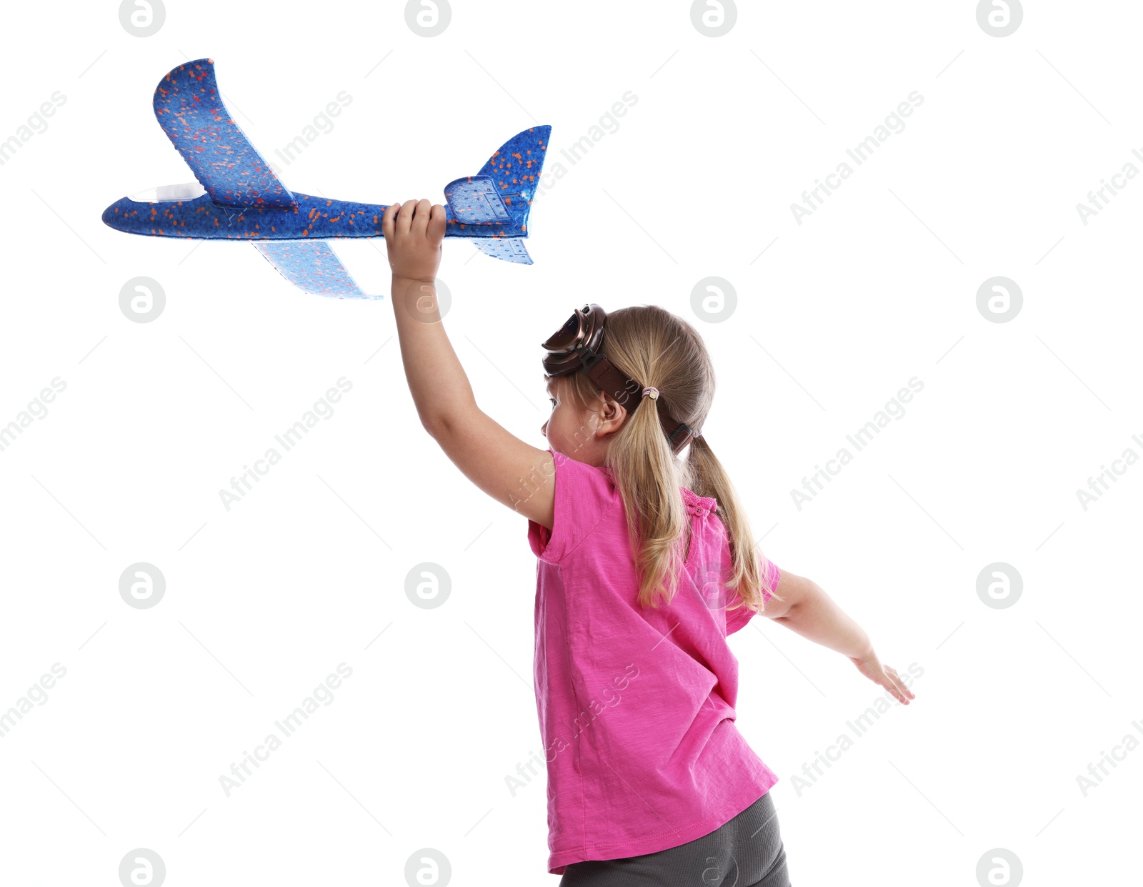 Photo of Cute little girl playing with toy plane on white background