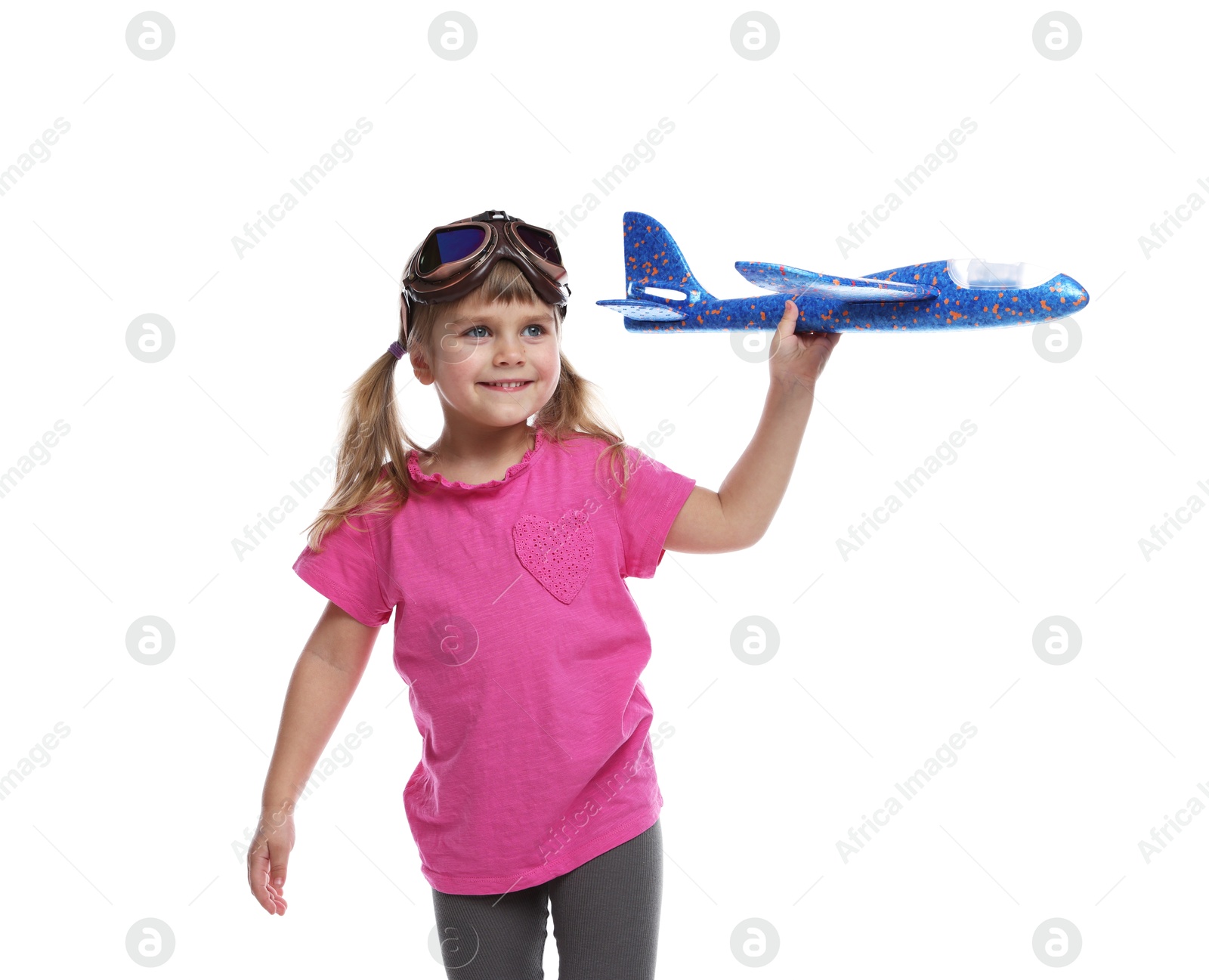 Photo of Cute little girl playing with toy plane on white background