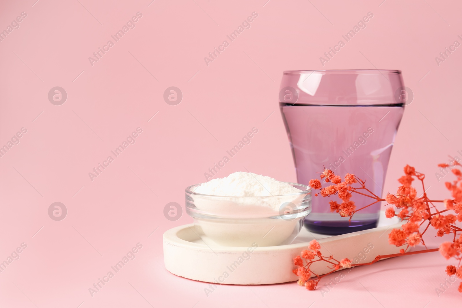 Collagen powder in bowl, glass of water and gypsophila branches on pink background, closeup. Space for text Photo of Collagen powder in bowl, glass of water and gypsophila branches on pink background, closeup. Space for text