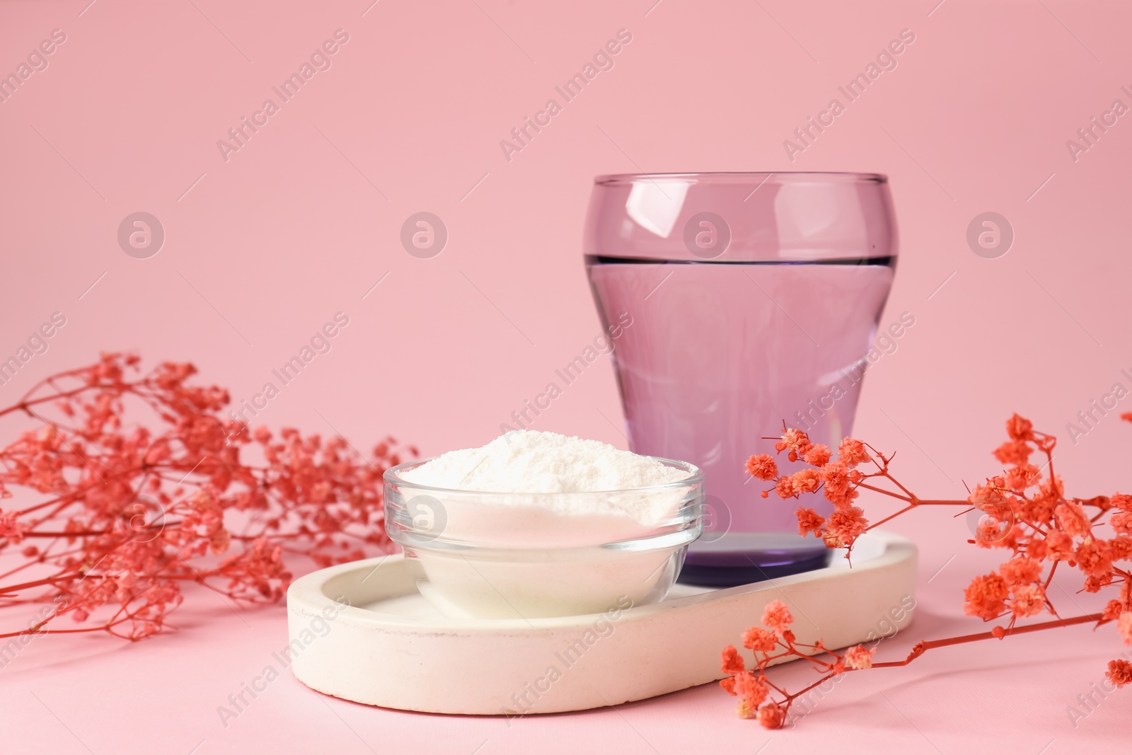 Collagen powder in bowl, glass of water and gypsophila branches on pink background, closeup Photo of Collagen powder in bowl, glass of water and gypsophila branches on pink background, closeup