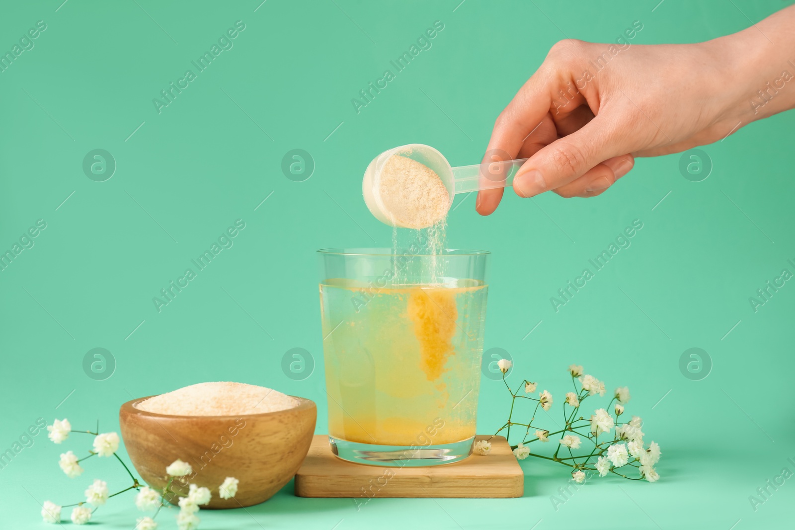 Woman adding collagen powder into glass with water on turquoise background, closeup Photo of Woman adding collagen powder into glass with water on turquoise background, closeup
