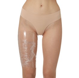 Photo of Woman doing spa body wraps on her leg against white background, closeup