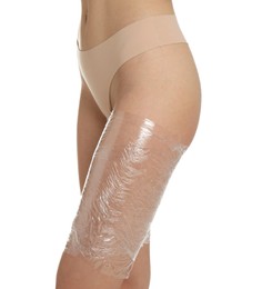 Photo of Woman doing spa body wraps on her leg against white background, closeup