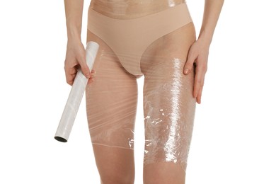 Photo of Woman doing spa body wraps on her leg against white background, closeup