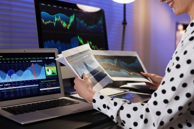 Photo of Stock exchange. Woman working in office at night, closeup