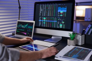 Photo of Stock exchange. Man working in office at night, closeup