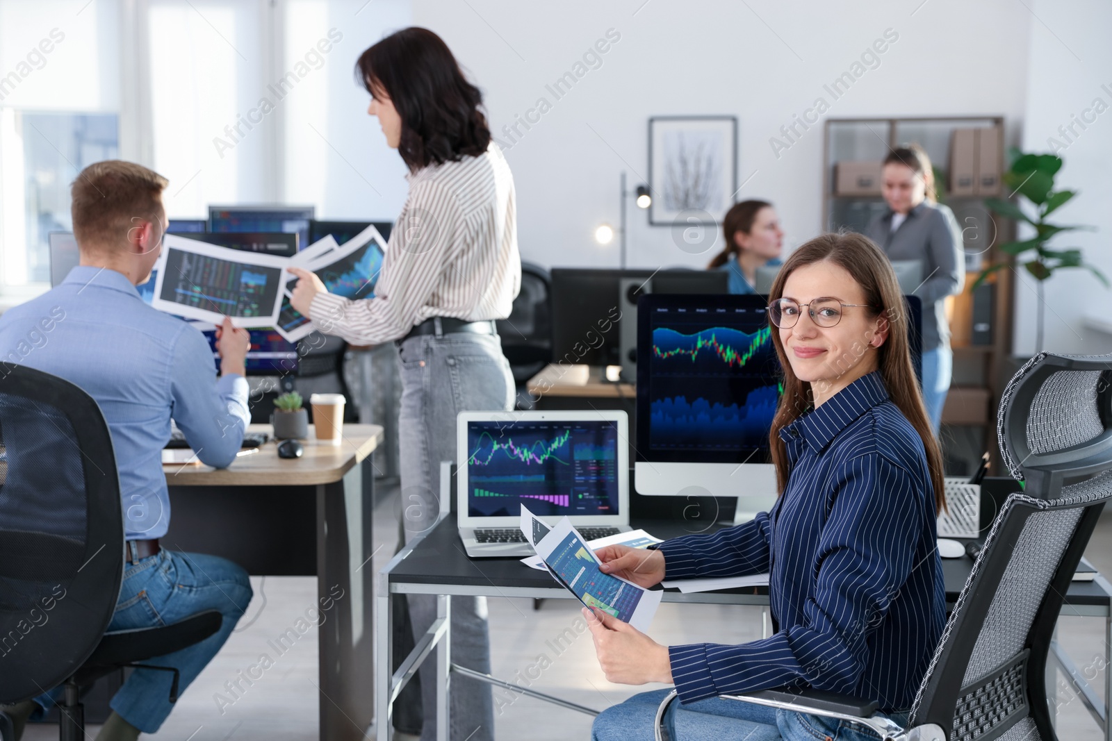 Photo of Stock exchange. Business team working together in office