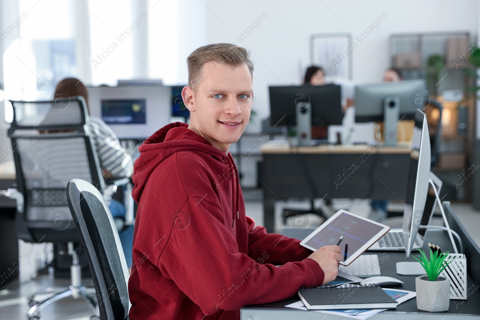 Photo of Stock exchange. Man working at desk in office