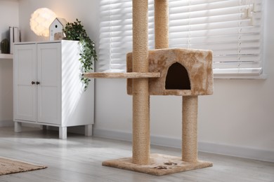 Photo of Stylish cat tree and chest of drawers in living room