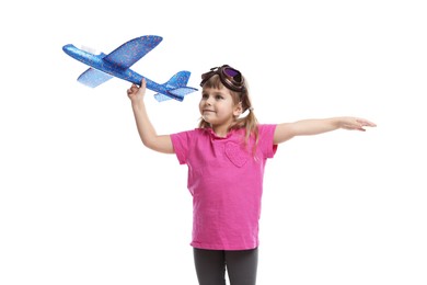 Photo of Cute little girl playing with toy plane on white background