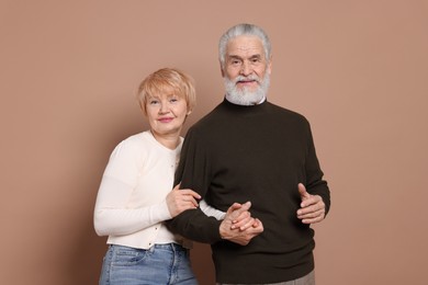 Photo of Portrait of lovely senior couple on beige background