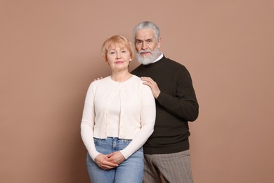 Photo of Portrait of lovely senior couple on beige background