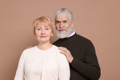 Photo of Portrait of lovely senior couple on beige background