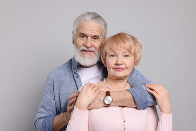 Photo of Portrait of lovely senior couple on grey background