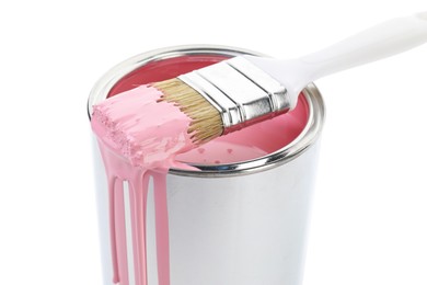 Photo of Can of pink paint and brush isolated on white