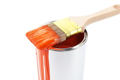 Photo of Can of orange paint and brush isolated on white