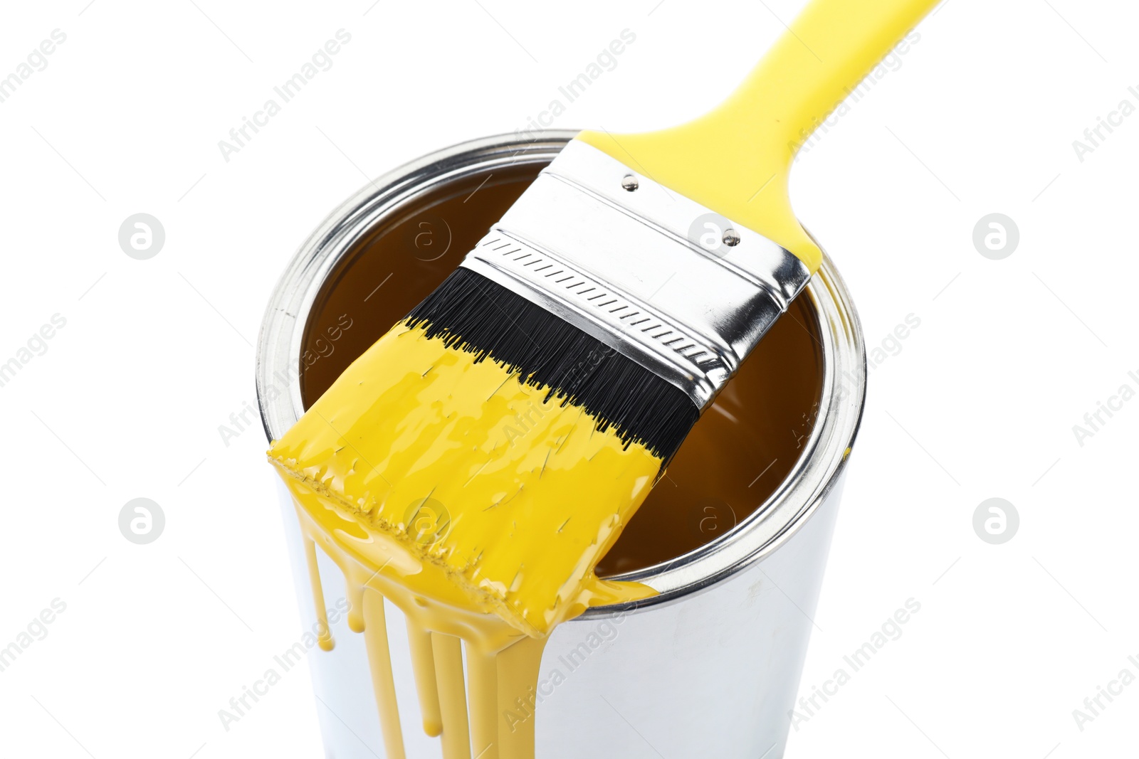 Photo of Can of yellow paint and brush isolated on white