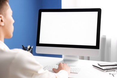 Photo of Man working on computer at white desk in office, closeup. Mockup for design