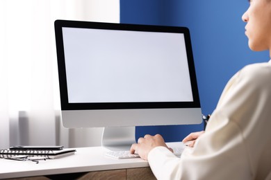 Photo of Man working on computer at white desk in office, closeup. Mockup for design