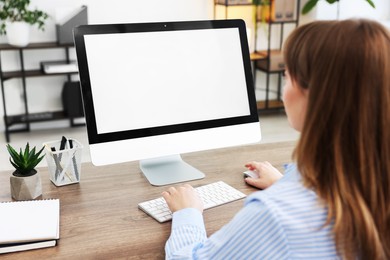 Photo of Woman working on computer at wooden desk in office. Mockup for design