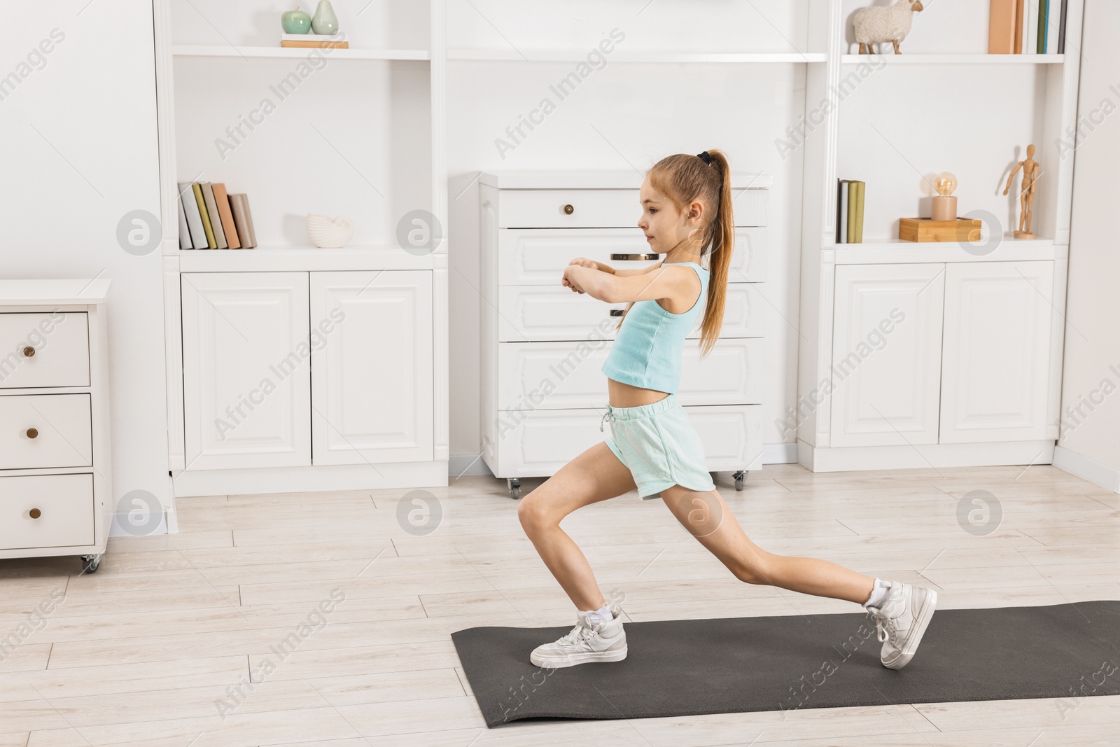 Photo of Little girl exercising at home, space for text. Morning routine