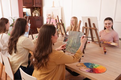 Photo of Group of women learning to draw at table in class