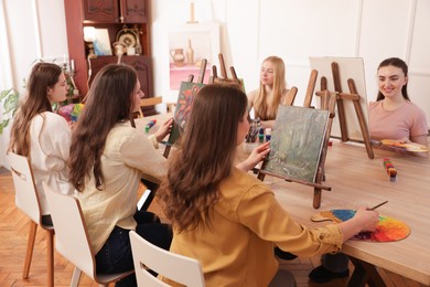 Photo of Group of women learning to draw at table in class