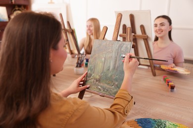 Photo of Group of women learning to draw at table in class