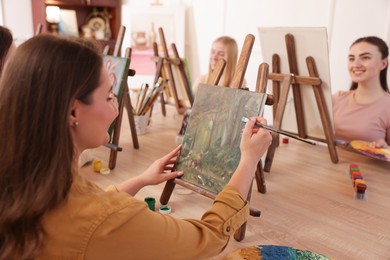 Photo of Group of women learning to draw at table in class