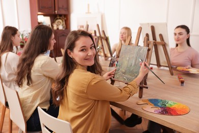 Photo of Group of women learning to draw at table in class