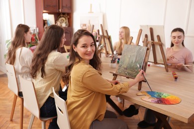 Photo of Group of women learning to draw at table in class