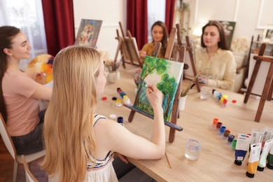 Photo of Group of women learning to draw at table in class