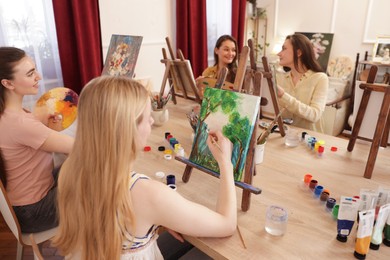 Photo of Group of women learning to draw at table in class